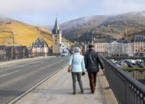 a man and a woman walking on a bridge