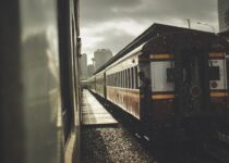 grayscale photo of train on rail tracks