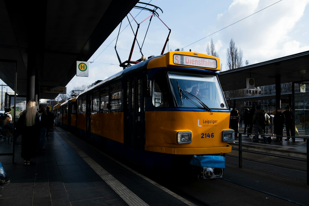 A yellow and blue tram at a station